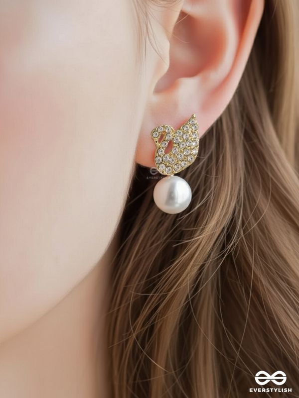 CELESTE SWAN – RADIANT WINGED STUDS WITH A CLASSIC PEARL DROP