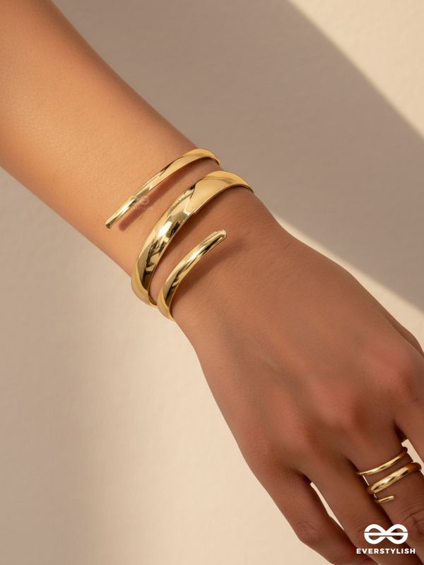 AURIC SWIRL - CONTEMPORARY GOLDEN TWIST RING+ TWISTED GLEAM- SLEEK AND POLISHED METALLIC CUFF BRACELET